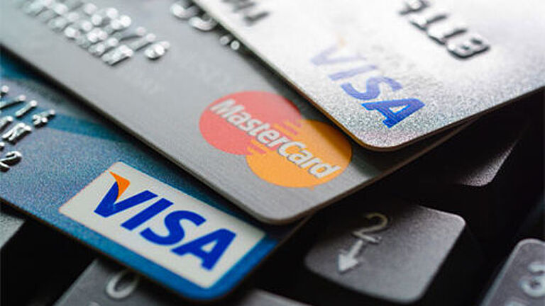 Image of several credit cards arranged on a surface, representing payment methods and financial transactions.